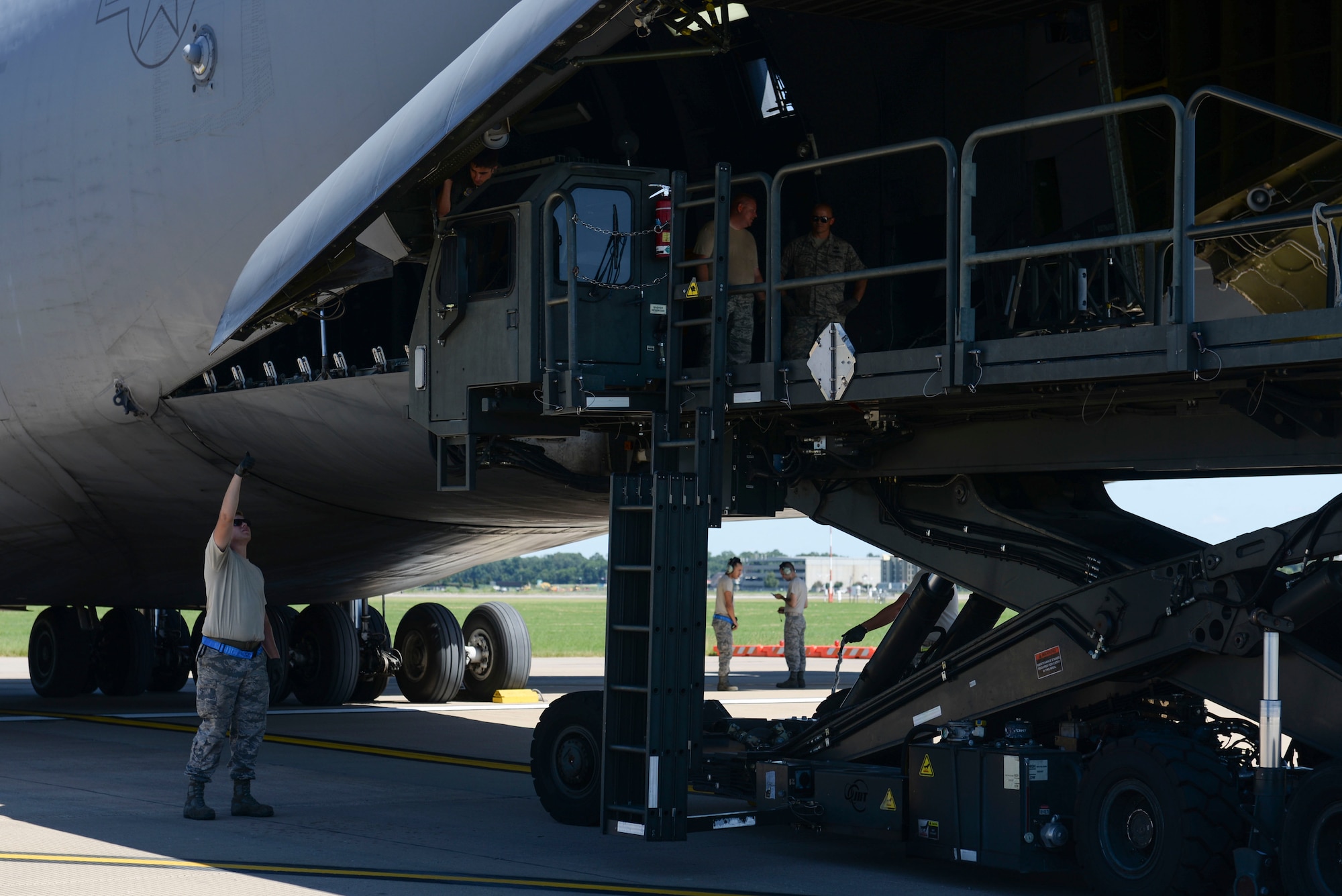 Team Little Rock members perform safety checks as they offload cargo on a C-5 Galaxy III assigned to Travis Air Force Base, Calif., July 30, 2017, at the Clinton National Airport. Little Rock Airmen plan to join more than 3,000 Air Force and joint service members, alongside 25 international partners, to train together during Mobility Guardian 2017 (U.S. Air Force Airman Rhett Isbell)