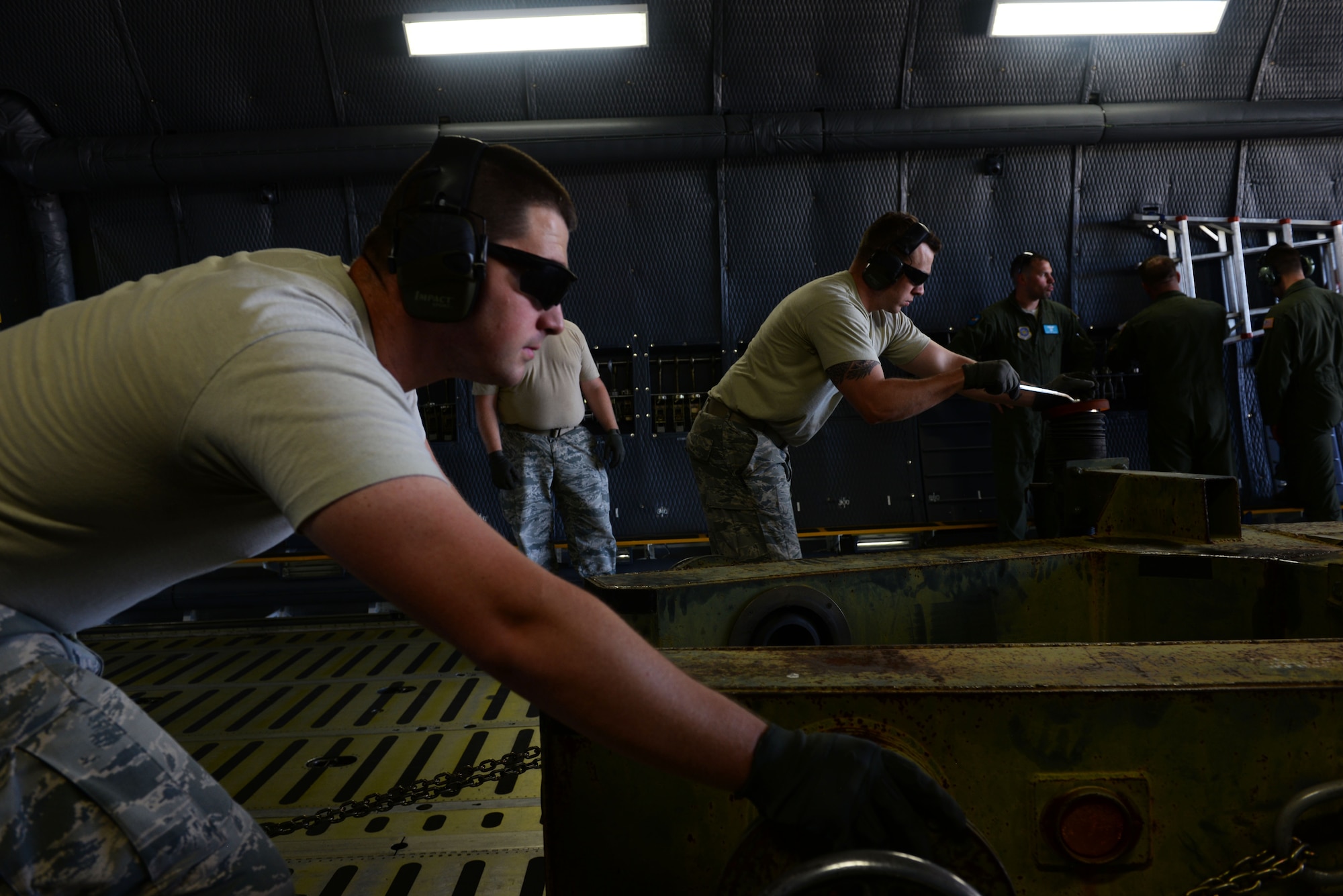 Senior Airman Troy Iversen and Staff Sgt. Jeffrey Braden, 19th Logistics Readiness Squadron aerial porters, push a tow bar off of a C-5 Galaxy III July, 30, 2017 at Clinton National Airport, Ark. More than 100 Team Little Rock members will lead, coordinate and execute maintenance operations during Mobility Guardian 2017. The exercise will test each of Air Mobility Command’s core competencies including airlift, aerial refueling, aeromedical evacuation and mobility support operations. (U.S. Air Force Airman Rhett Isbell)