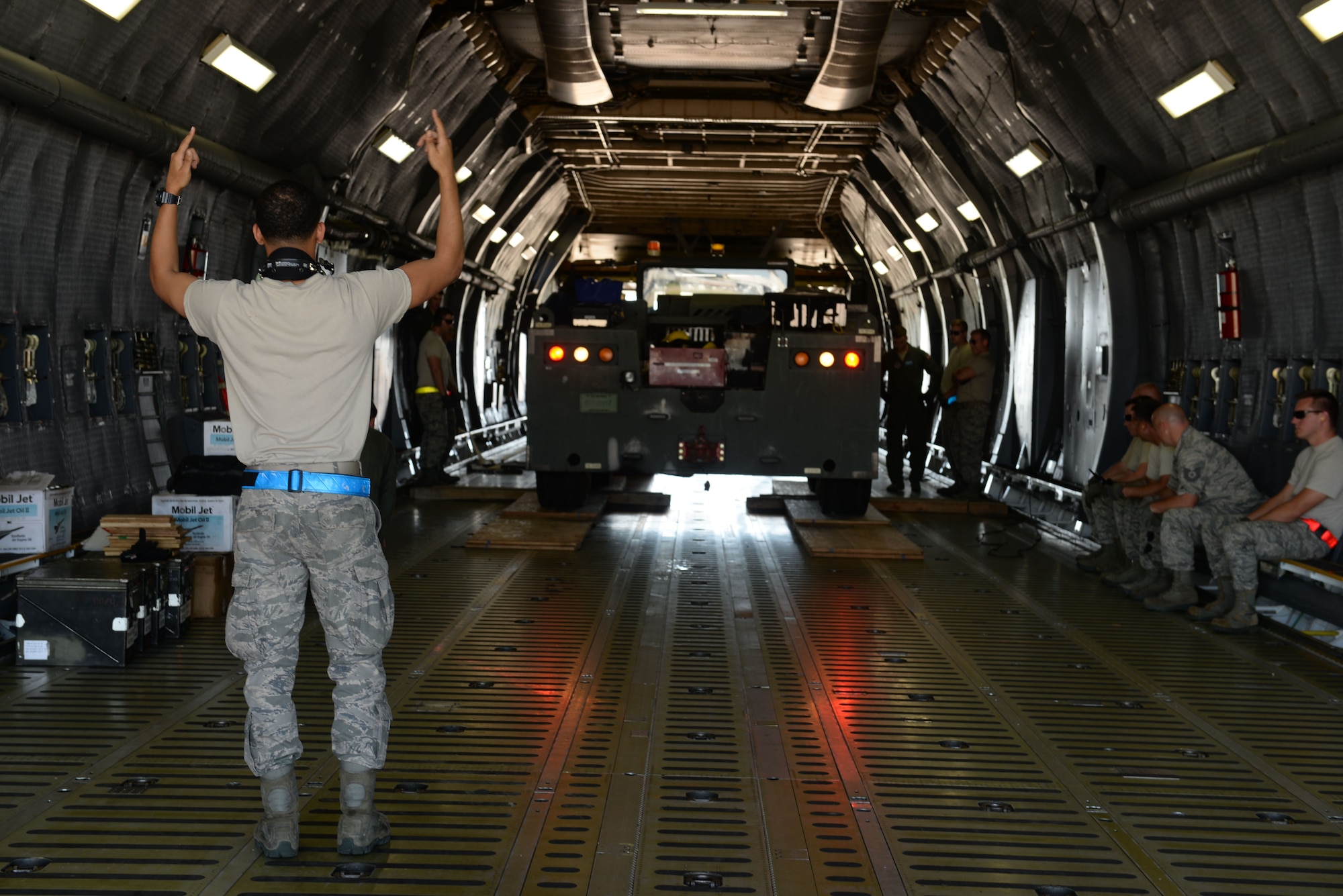 Members of the 19th Logistics Readiness Squadron offload a tow tractor from C-5 Galaxy III July 30, 2017, at the Clinton National Airport, Ark. Team Little Rock Airmen will join more than 3,000 service members for Mobility Guardian. Exercises such as Mobility Guardian allow Airmen to undertake critical, realistic, and relevant training for our Mobility Air Forces. (U.S. Air Force Airman Rhett Isbell)
