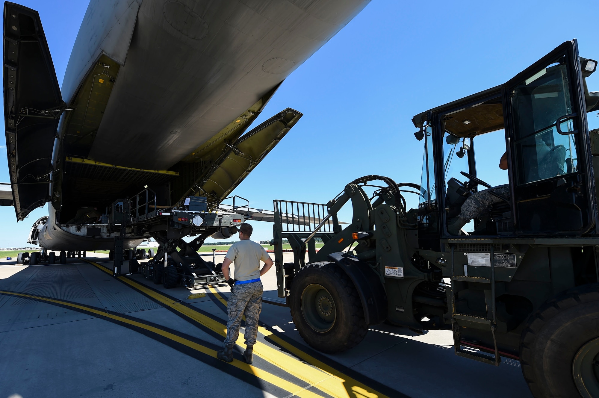 A member of the 19th Logistics Readiness Squadron prepares to offload equipment from a C-5 Galaxy III July 30, 2017, at the Clinton National Airport, Ark. The aircraft landed in Little Rock, Ark. in preparation of the Mobility Guardian exercise. (U.S. Air Force photo by Staff Sgt. Harry Brexel)