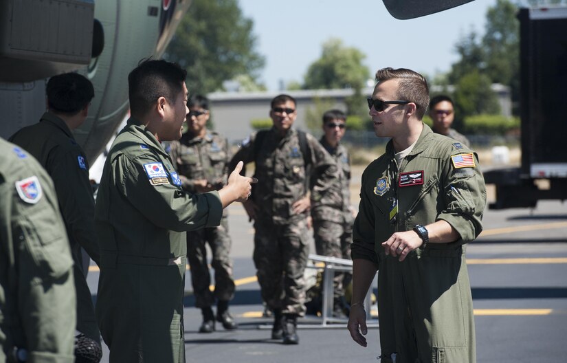 Air Force Capt. Mark Bishop, KC-10 Extender aircraft commander from Joint Base McGuire-Dix-Lakehrust, N.J., and international relations team member, greets South Korean airmen upon their arrival to the Mobility Guardian exercise at Joint Base Lewis-McChord, Wash., July 29, 2017. Air Force photo by Senior Airman Lauren Russell