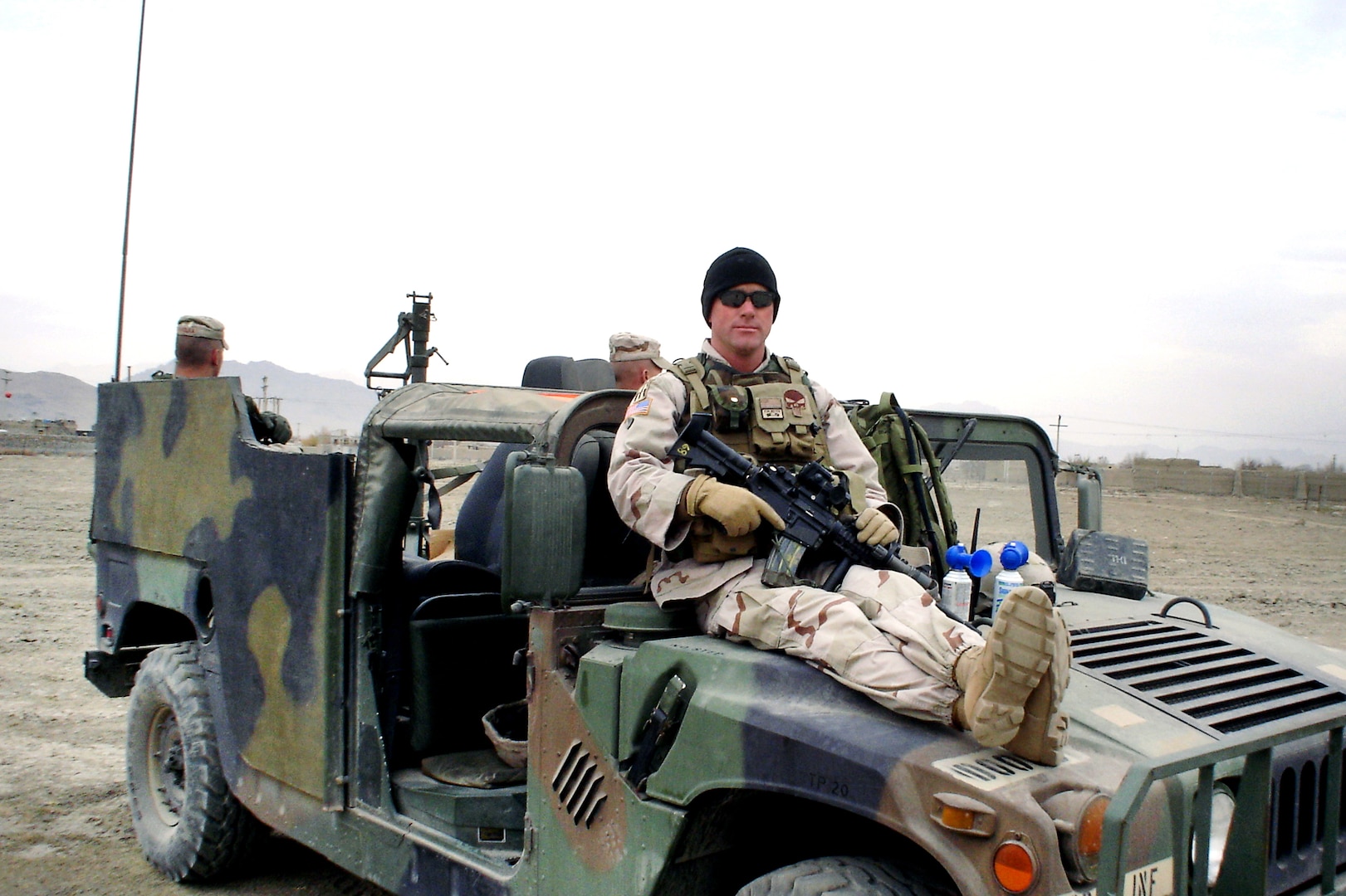 Then-Staff Sgt. Tom Farrington sits on the hood of a Humvee during a halt on a mission while deployed to Iraq in 2004 with the Indiana Army National Guard’s D Company (Long Range Surveillance), 1st Battalion, 151st Infantry Regiment. 