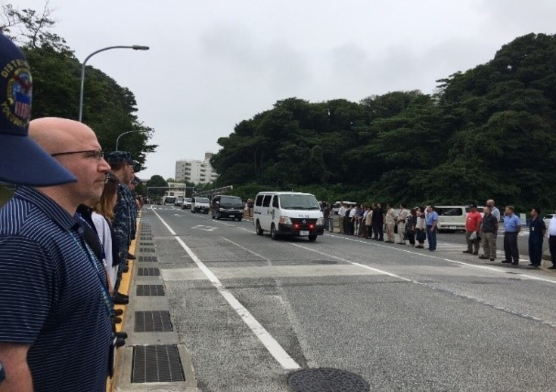 Members of the Commander Fleet Activities Yokosuka community come together to participate in a “Line of Honor,” honoring the crew and families of the USS Fitzgerald.  