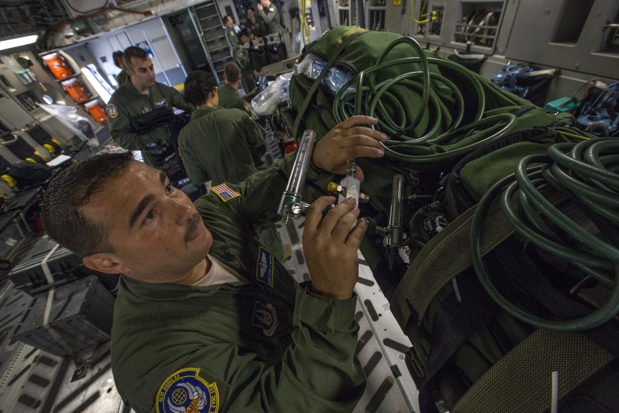 U.S. Air Force Master Sgt. Louis J. Muzyka, aeromedical evacuation technician, 514th Aeromedical Evacuation Squadron, 514th Air Mobility Wing, sets up a patient oxygen supply system during an aeromedical evacuation training mission onboard a 305th Air Mobility Wing C-17 Globemaster III to Nashville, Tenn., July 29, 2017. The training’s purpose is to teach flight nurses and aeromedical evacuation technicians how to respond to scenarios during the evacuation of sick or wounded personnel, and how to handle medical situations that might occur during the flight. The 514th Aeromedical Evacuation Squadron is located at Joint Base McGuire-Dix-Lakehurst, N.J. (U.S. Air Force photo by Master Sgt. Mark C. Olsen/Released)