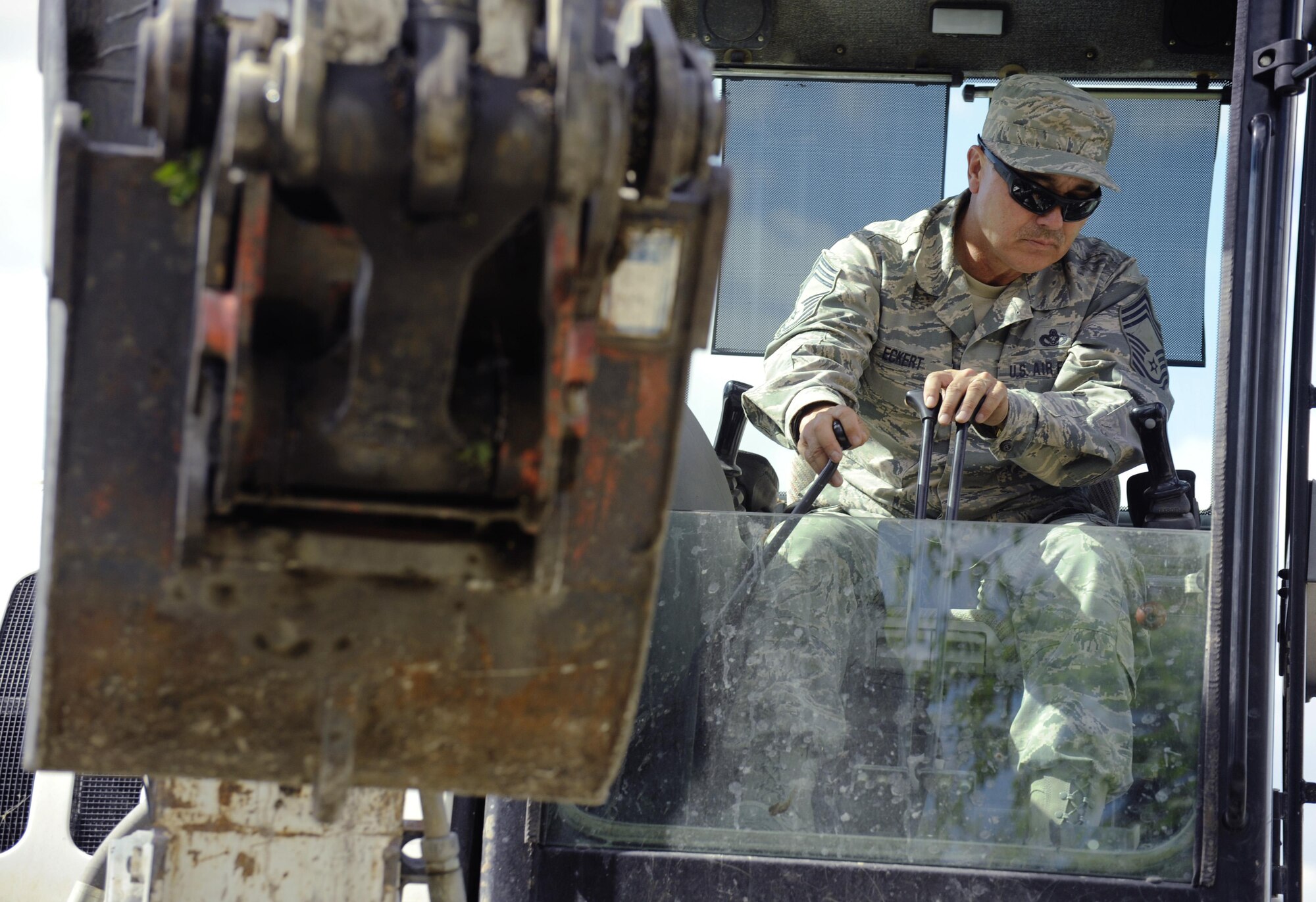 Oregon Air National Guard Chief Master Sgt. Ronald Eckert, 142nd Fighter Wing Civil Engineers (CES), operates a excavator to load rock and other materials used to build a new trail at Niven Lake, Yellowknife, Northern Territories, Canada, July 18, 2017. Over 30 CES members are spending two-weeks in Canada working on a variety of projects during their Deployment for Training (DFT). (U.S. Air National Guard photo/Master Sgt. John Hughel, 142nd Fighter Wing Public Affairs)