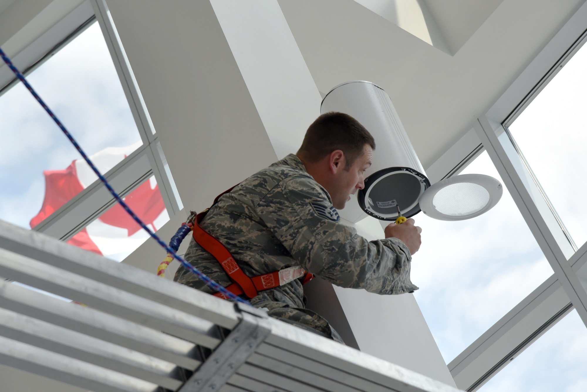 Oregon Air National Guard Christoper Black, assigned to the 142nd Fighter Wing Civil Engineer Squadron (CES) works to install new lights at the Joint Task Force North (JTFN) Headquarters building, Yellowknife, Northwest Territories, Canada, July 21, 2017. The Oregon CES members are deployed for two-weeks for training along with CAF members from Cold Lake, Alberta. (U.S. Air National Guard photo/Master Sgt. John Hughel, 142nd Fighter Wing Public Affairs)