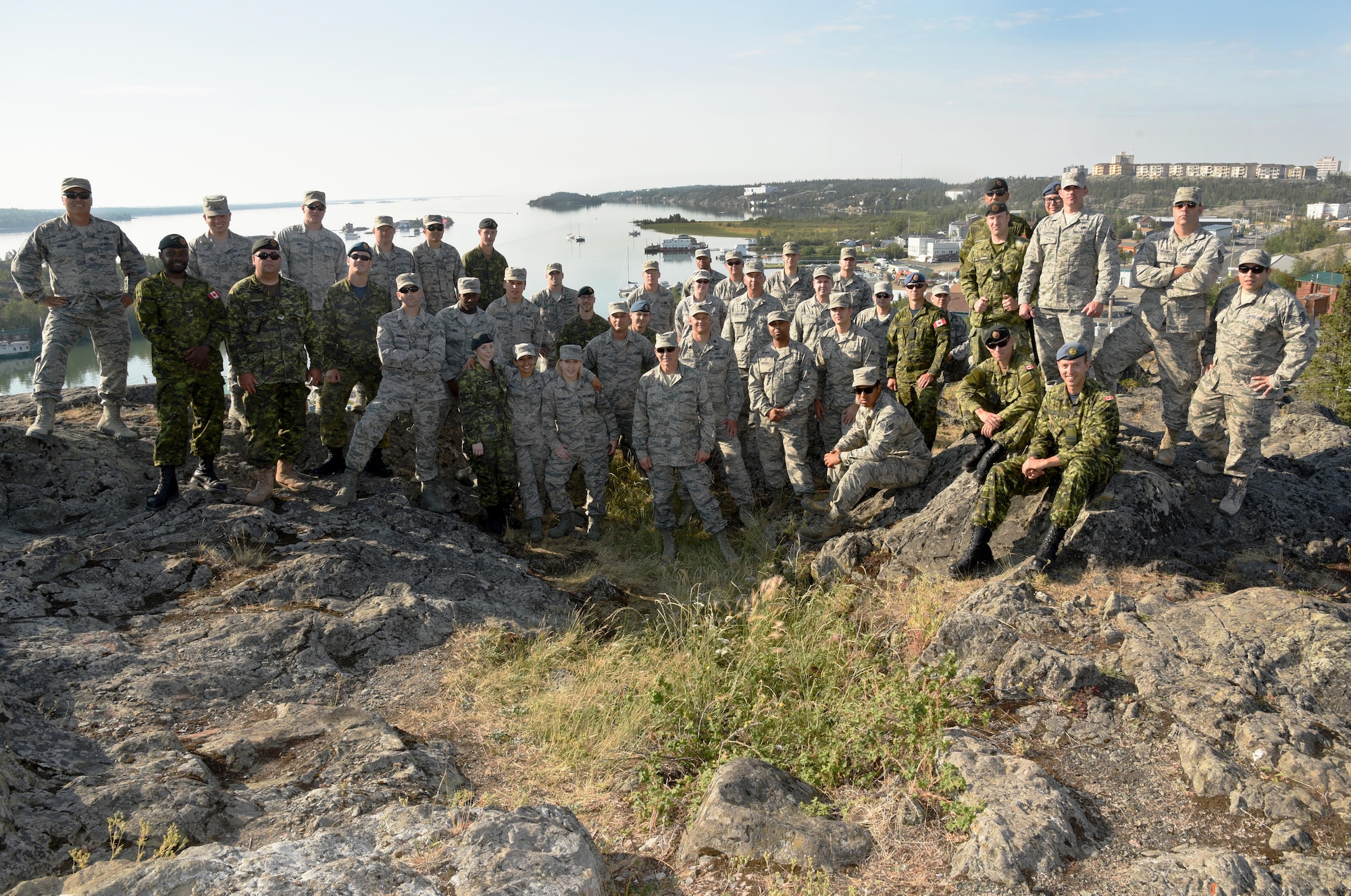 Oregon Air National Guardsmen from the 142nd Fighter Wing Civil Engineer Squadron (CES) along with Canadian Armed Forces Construction Engineers from Cold Lake, Alberta, gather for a group photograph after their two-week Deployment for Training assigment in Yellowknife, Northwest Territories, Canada, July 26, 2017. (U.S. Air National Guard photo/Master Sgt. John Hughel)