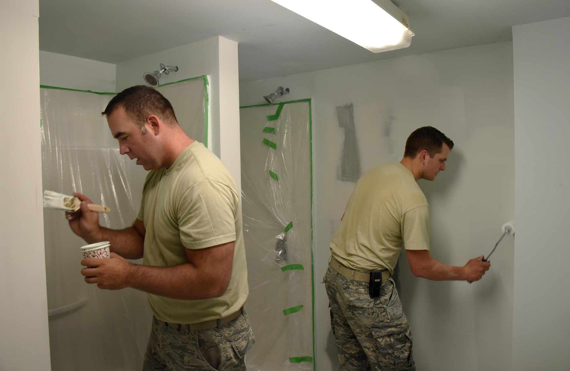 Oregon Air National Guard Staff Sgt. Tyler O'Bryant (left), and Staff Sgt. Zachariah Lewis (right), assigned to the 142nd Fighter Wing Civil Engineer Squadron, apply paint to  a shower repair project during their Deployment For Training (DFT) in Yellowknife, Northwest Territories, Canada, July 27, 2017. The Oregon Airmen are also collaborating with Canadian Armed Forces members from Cold Lake, Alberta, who are also deployed to Yellowknife for training. (U.S. Air National Guard photo/Master Sgt. John Hughel, 142nd Fighter Wing Public Affairs)