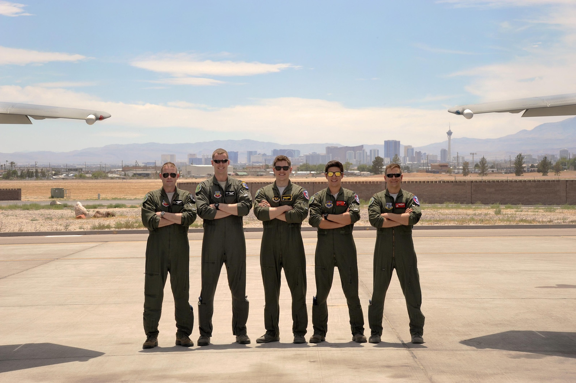 U.S. Air Force fighter pilots completing their 6-month course at Nellis Air Force Base, Nev., (from left to right) Maj. Kevin Danaher, Capt. Ryan Sivertsen, Capt. Matt Tanis, Capt. Nathan Liptak, and 142nd Fighter Wing Maj. Bradley Young, pause for a group photograph, June 10, 2017. (U.S. Air National Guard photo by Master Sgt. John Hughel, 142nd Fighter Wing Public Affairs)