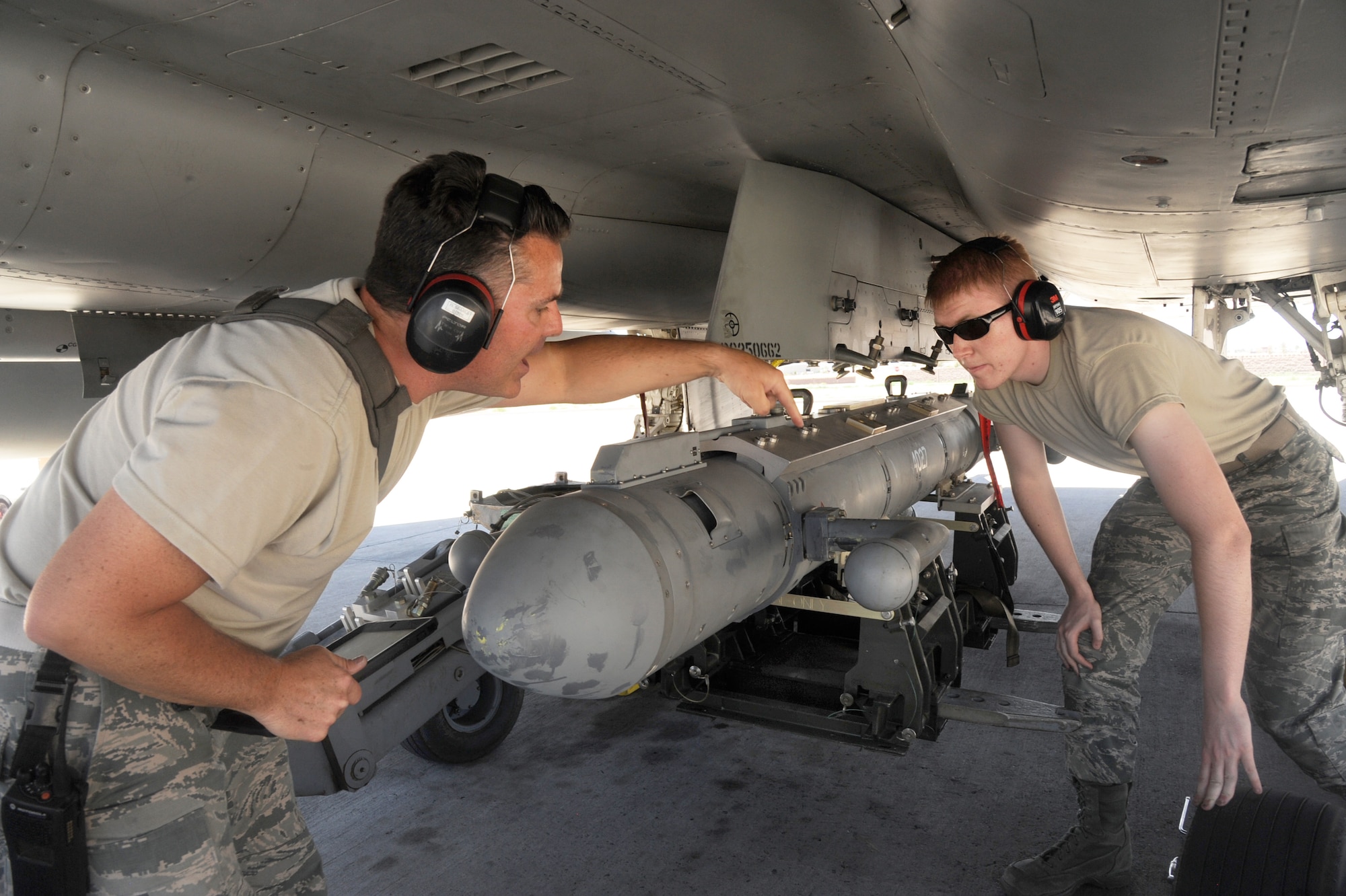 Oregon Air National Guard Avionics Technicians Master Sgt. Haina Searls (left) and Senior Airman Darian Forbes (right), assigned to the 142nd Fighter Wing Maintenance Group, work to install the AN/ALQ-188 pod to a F-15 Eagle, assigned to the 142nd Fighter Wing prior to an afternoon flight in support of the Weapons Instructor Course at Nellis Air Force Base, Nev., June 14, 2017. (U.S. Air National Guard photo by Tech. Sgt. John Hughel, 142nd Fighter Wing Public Affairs)