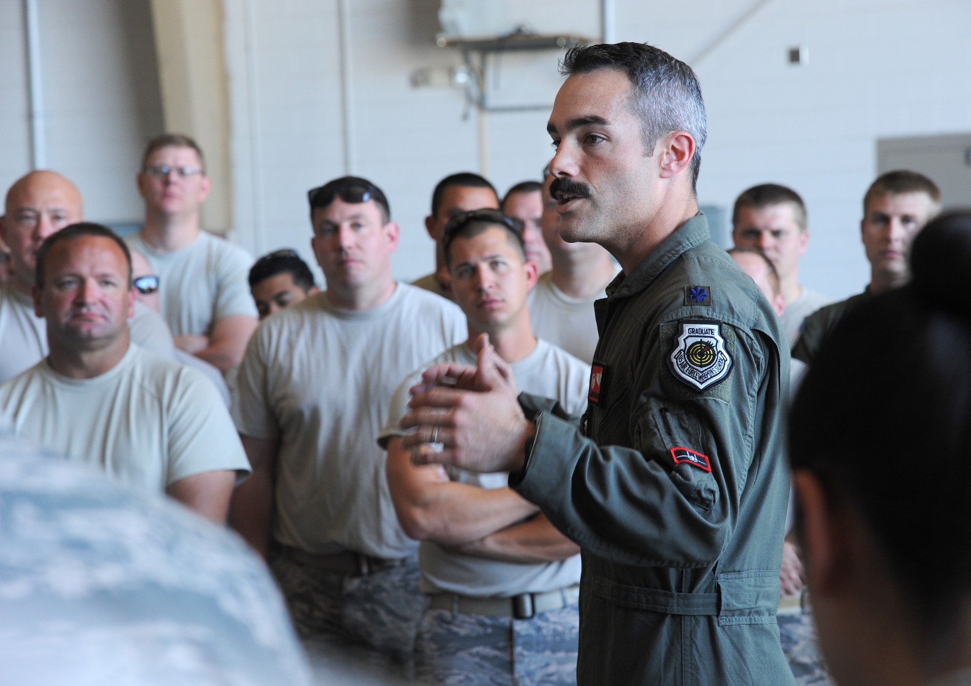 Oregon Air National Guard Lt. Col. Aaron Mathena, 123rd Fighter Squadron commander, spends time thanking and providing thoughtful feedback to members of the 142nd Fighter Wing who spent the last three-weeks at Nellis Air Force Base, Nev., supporting the Weapons Instructor Course.
