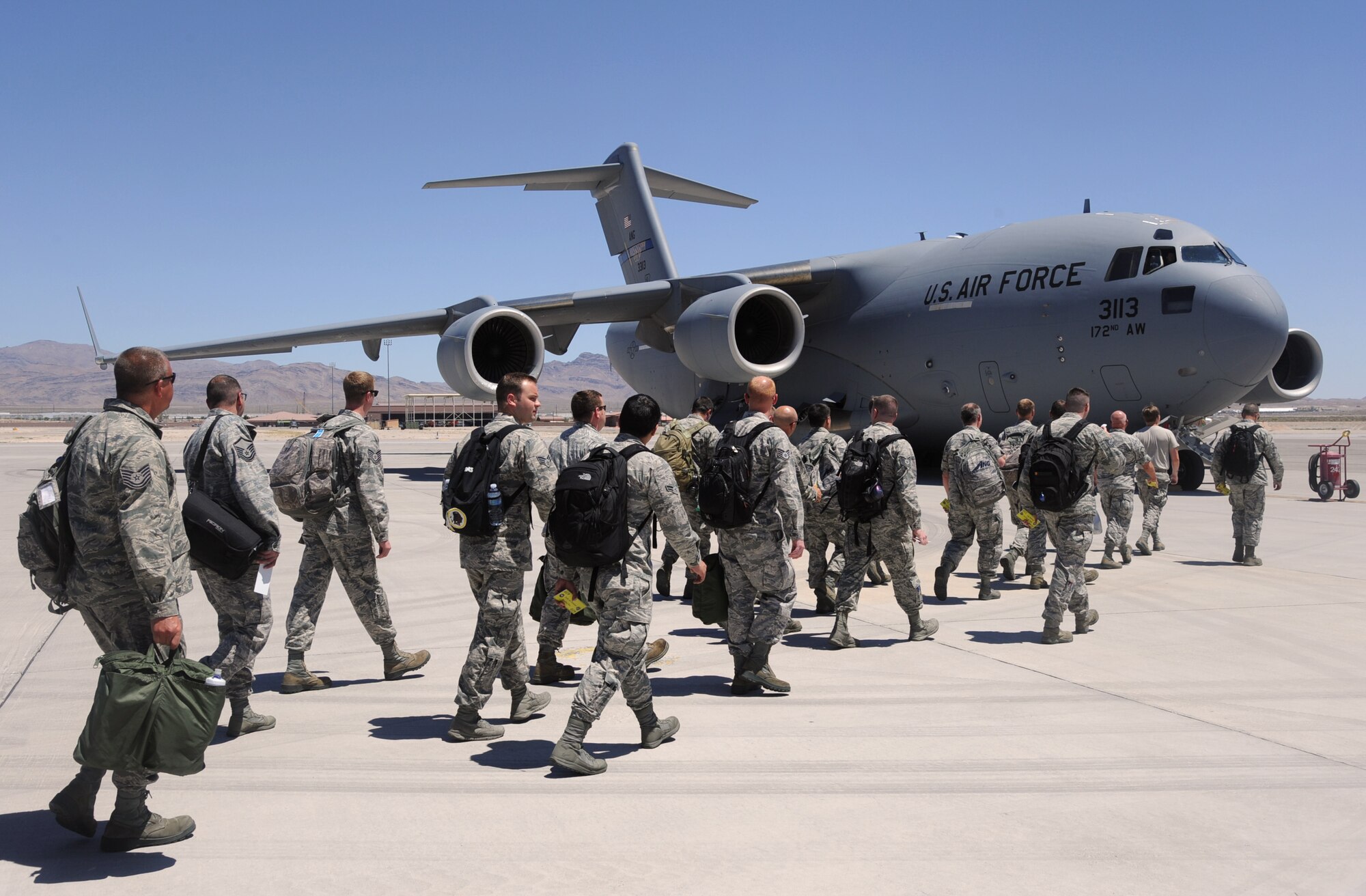 Members of the Oregon Air National Guard 142nd Fighter Wing prepare to board a C-17 Globemaster III, assigned to the 172nd Airlift Wing, Mississippi Air National Guard, as they leave Nellis Air Force Base, Nev., June 16, 2017. The Oregon Airmen spent three-weeks on temporary duty supporting the Weapons Instructor Course. (U.S. Air National Guard photo by Master Sgt. John Hughel, 142nd Fighter Wing Public Affairs) 