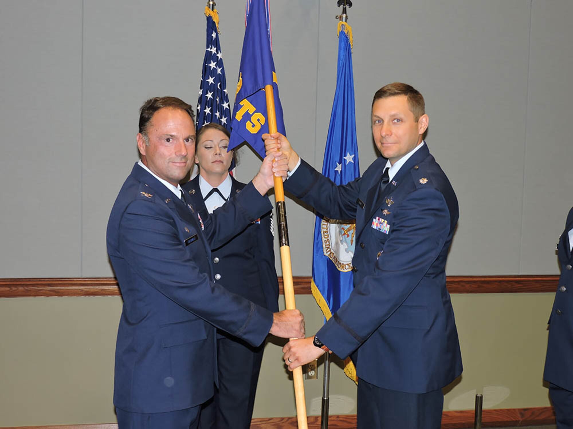 (Right) Lt. Col. Adam Fisher, 14th Test Squadron Commander, receives the guidon from Col. Dean Caldwell, 926th Operations Group Commander, during a change of command ceremony July 8 at the Air Force Warfare Center. (U.S. Air Force photo/Senior Airman Victoria Carr)