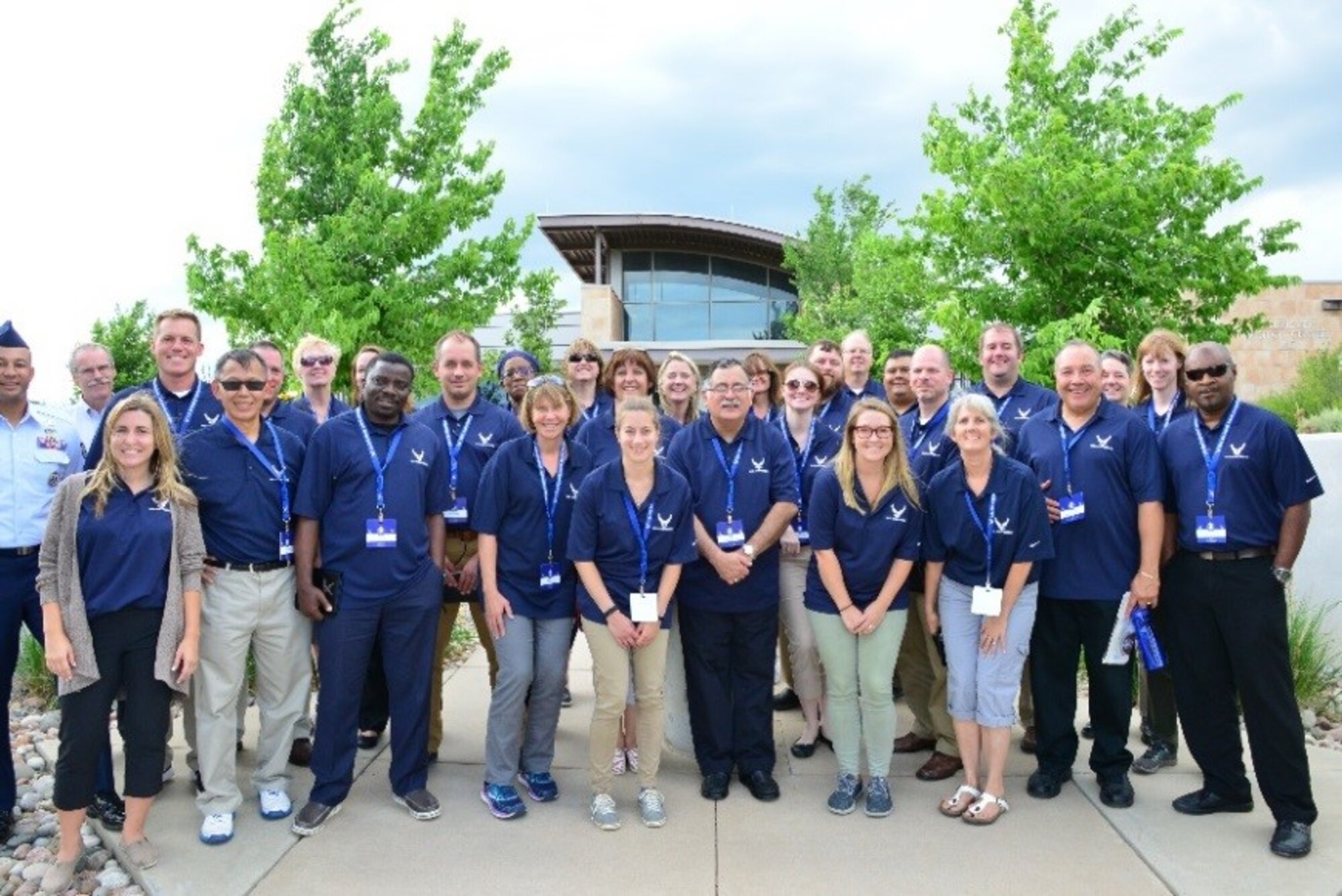 FIRST Educators Tour attendees gather for a photo in front of the Visitor’s Center at Schriever Air Force Base, Colorado, Tuesday, July 25, 2017. The mission of FIRST is to inspire young people to be science and technology leaders and innovators. (U.S. Air Force photo/Halle Thornton)