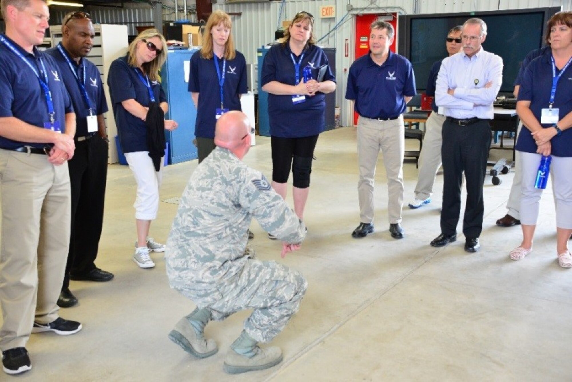 Tech. Sgt. Christopher Pepau, 527th Space Aggressors Squadron, NCOIC adversary support flight operations, performs technical demonstrations, such as how to detonate a bomb, for members of the FIRST Educators Tour at Schriever Air Force Base, Colorado, Tuesday, July 25, 2017. Guests learned about how science, technology, engineering and math support the base missions. (U.S. Air Force photo/Halle Thornton)