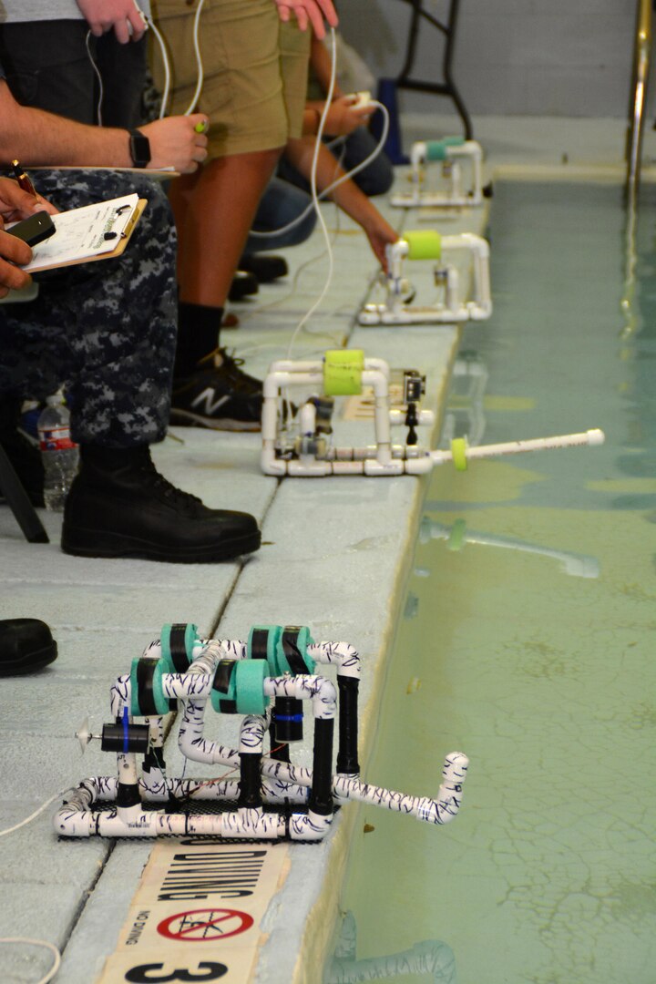 Teams of middle and high school students line up their SeaPerch, underwater remotely-operated vehicles during a scrimmage at the Eastside Branch Boys & Girls Club July 27. The event was held on the final day of the SeaPerch Regional Challenge Prep Camp hosted by Northeast Lakeview College and the Boys & Girls Clubs of San Antonio, in cooperation with Navy City Outreach Southwest Region and Navy Recruiting District (NRD) San Antonio. The scrimmage consisted of the Speed Obstacle and Challenge Courses. 