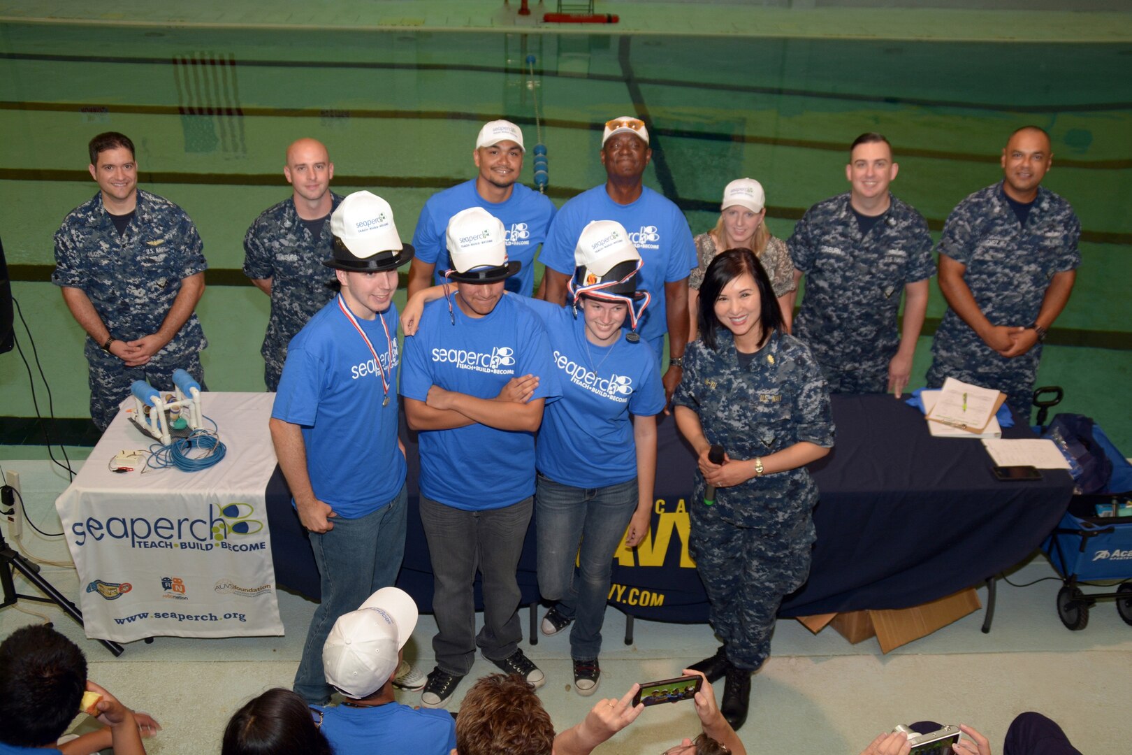 Houston native Lt. Diana Tran-Yu, assigned to Navy City Outreach Southwest Region, stands with Team Sub-Zero, who placed first in a SeaPerch scrimmage held at the Eastside Branch Boys & Girls Club July 27. The event was held on the final day of the SeaPerch Regional Challenge Prep Camp hosted by Northeast Lakeview College and the Boys & Girls Clubs of San Antonio, in cooperation with Navy City Outreach Southwest Region and Navy Recruiting District (NRD) San Antonio. The scrimmage consisted of the Speed Obstacle and Challenge Courses. 