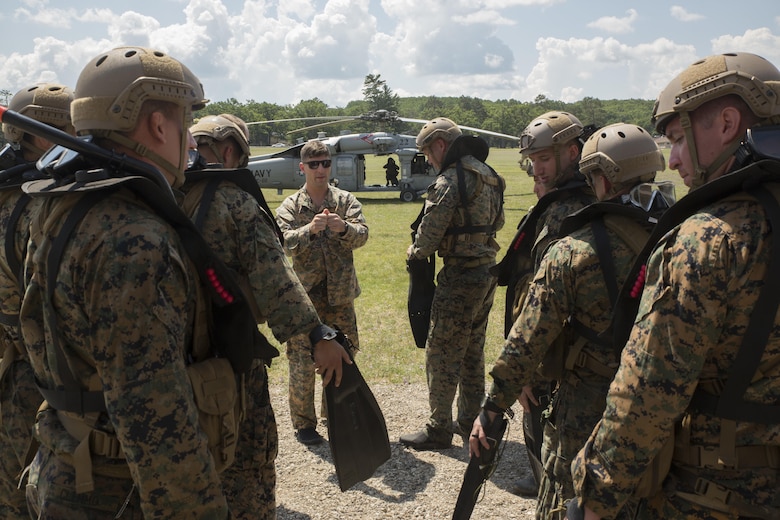 CAMP GRAYLING, Mich. – U.S. Marines with Echo Company, 4th Reconnaissance Battalion, 4th Marine Division, Marines Forces Reserve, listen to a final brief before conducting a helocast exercise off of a U.S. Navy Sikorsky SH-60 Seahawk from Sea Combat Squadron 22 at Camp Grayling Joint Maneuver Training Center, Michigan, during exercise Northern Strike 17, July 31, 2017. Helocasting is an airborne technique used by small units and special operations for insertion into military areas of operations. Exercise Northern Strike is a National Guard Bureau-sponsored training exercise that unites service members from multiple branches, states and coalition countries to conduct combined ground and air combat operations.  (U.S. Marine Corps photo by Lance Cpl. Niles Lee/Released)