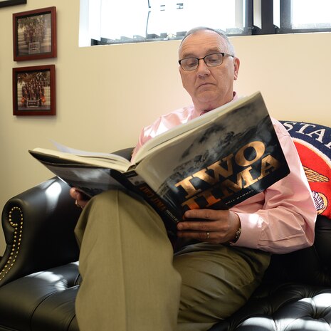 Kent Morrison, executive director, Marine Corps Logistics Base Albany, studies the Battle of Iwo Jima during his down time recently. 