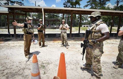 Tech. Sgt. Samuel Weaver, 1st Combat Camera Squadron Weapons and Tactics Training NCO in charge, left, instructs weapons and tactical movement training event at Fort Jackson, South Carolina, July 20, 2017. The operational mission at Combat Camera is fast paced with a high-ops tempo. Beyond performing visual documentation, combat photojournalists and broadcasters need to be fully trained and qualified with weapons and tactics to operate in joint environments and real-world contingencies.