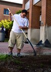 Alberto Talance, a member of the Direct Link program, smiles as he rakes leaves July 26, 2017, here. Through the Direct Link Program, Talance and many others learn the skills needed to be effective workers in the community. (U.S. Air Force Photo by Senior Airman Jeffrey Grossi.)