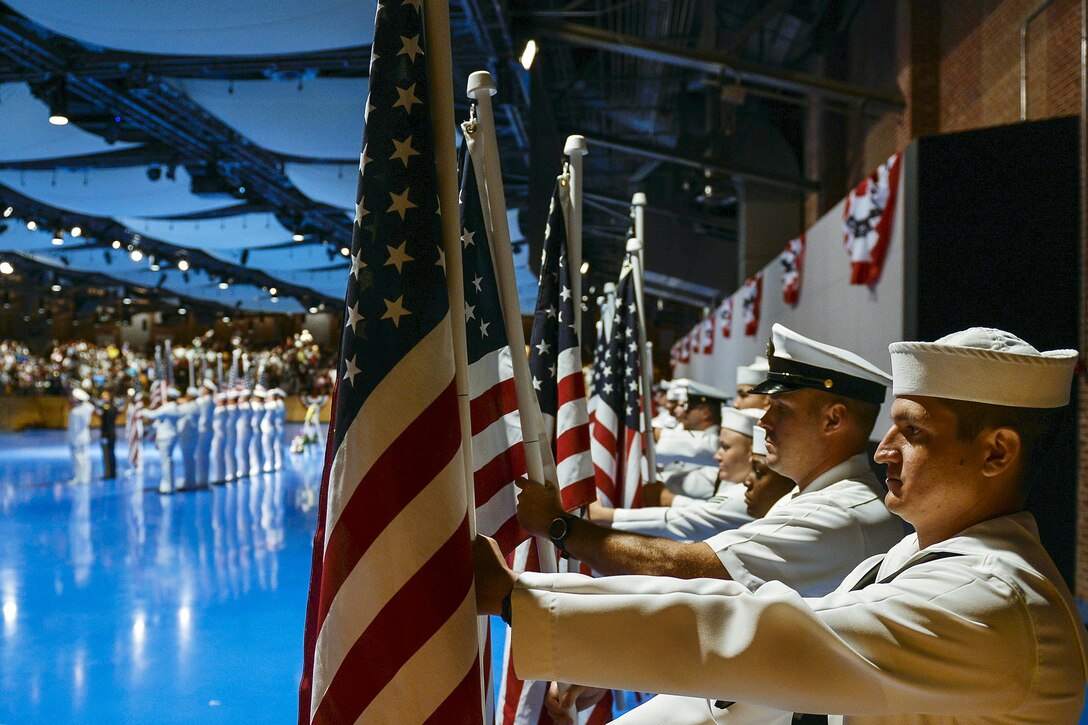 Sailors present flags representing the 134 sailors who died during the fire aboard the aircraft carrier USS Forrestal 50 years ago during a ceremony to commemorate the tragedy at Joint Base Fort Myer-Henderson Hall in Arlington, Va., July 31, 2017. More than 250 survivors and their families attended the ceremony. Navy photo by Petty Officer 2nd Class Jason Amadi