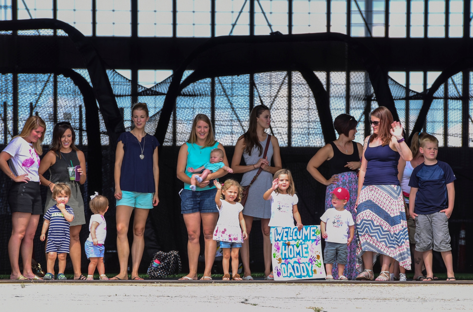 Families await their loved ones returning from Nellis Air Force Base, Nevada, after participating in Red Flag 17-3, July 29, 2017. Airmen from Ellsworth spent nearly a month in the Nevada heat, maintaining B-1 bombers and supporting the aircrews that partook in the world’s largest combat exercise. (U.S. Air Force photo by Airman 1st Class Randahl J. Jenson) 