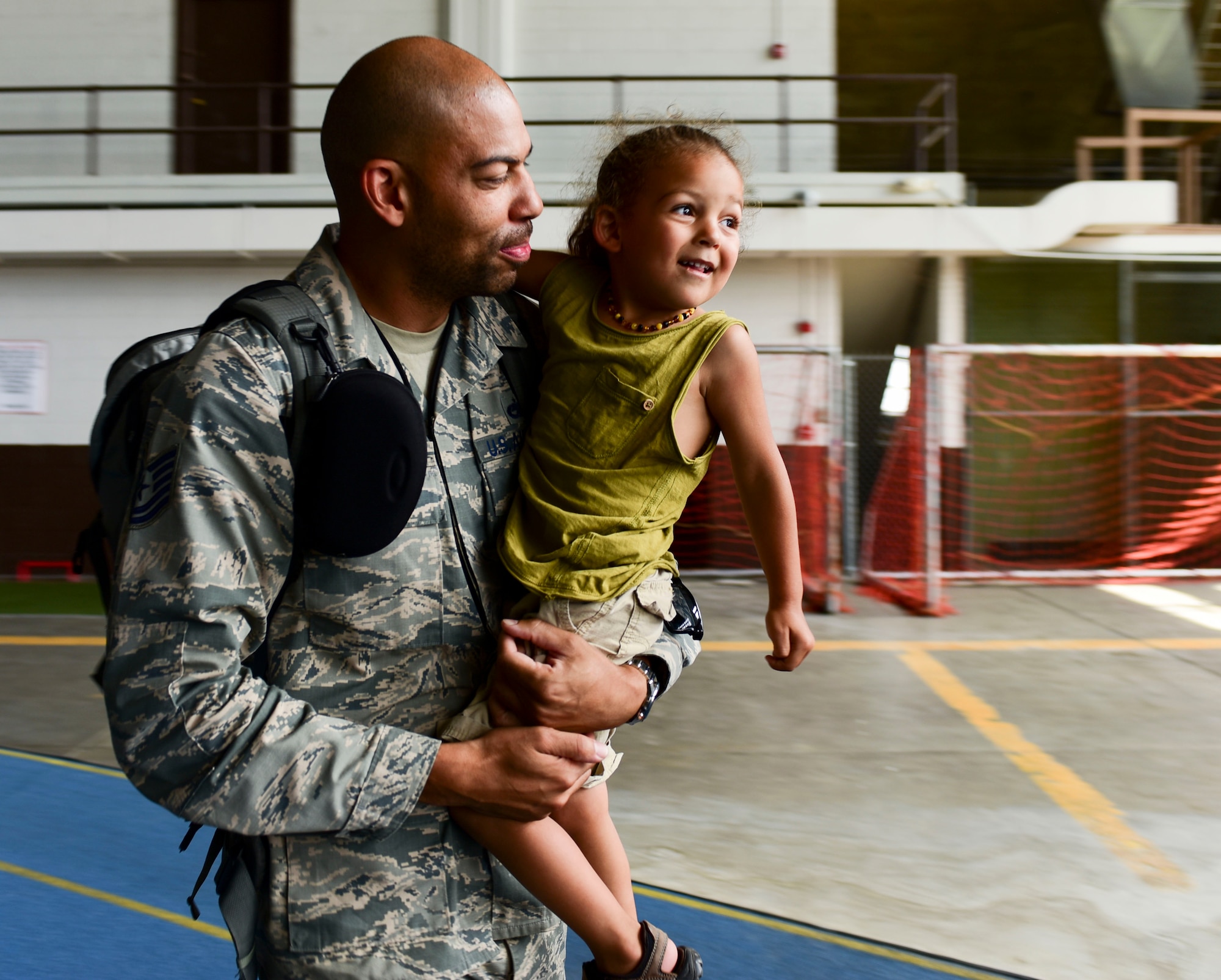 Tech Sgt. Eric Clayborn, an aircraft fuels craftsman assigned to the 28th Maintenance Squadron, holds his three-year old son, Zion, after returning from Red Flag 17-3, July 29, 2017. Red Flag is a joint-exercise that occurs at Nellis Air Force Base, Nevada, and includes air-to-air and air-to-ground scenarios to provide aircrews with a realistic combat environment. (U.S. Air Force photo by Airman 1st Class Randahl J. Jenson)  