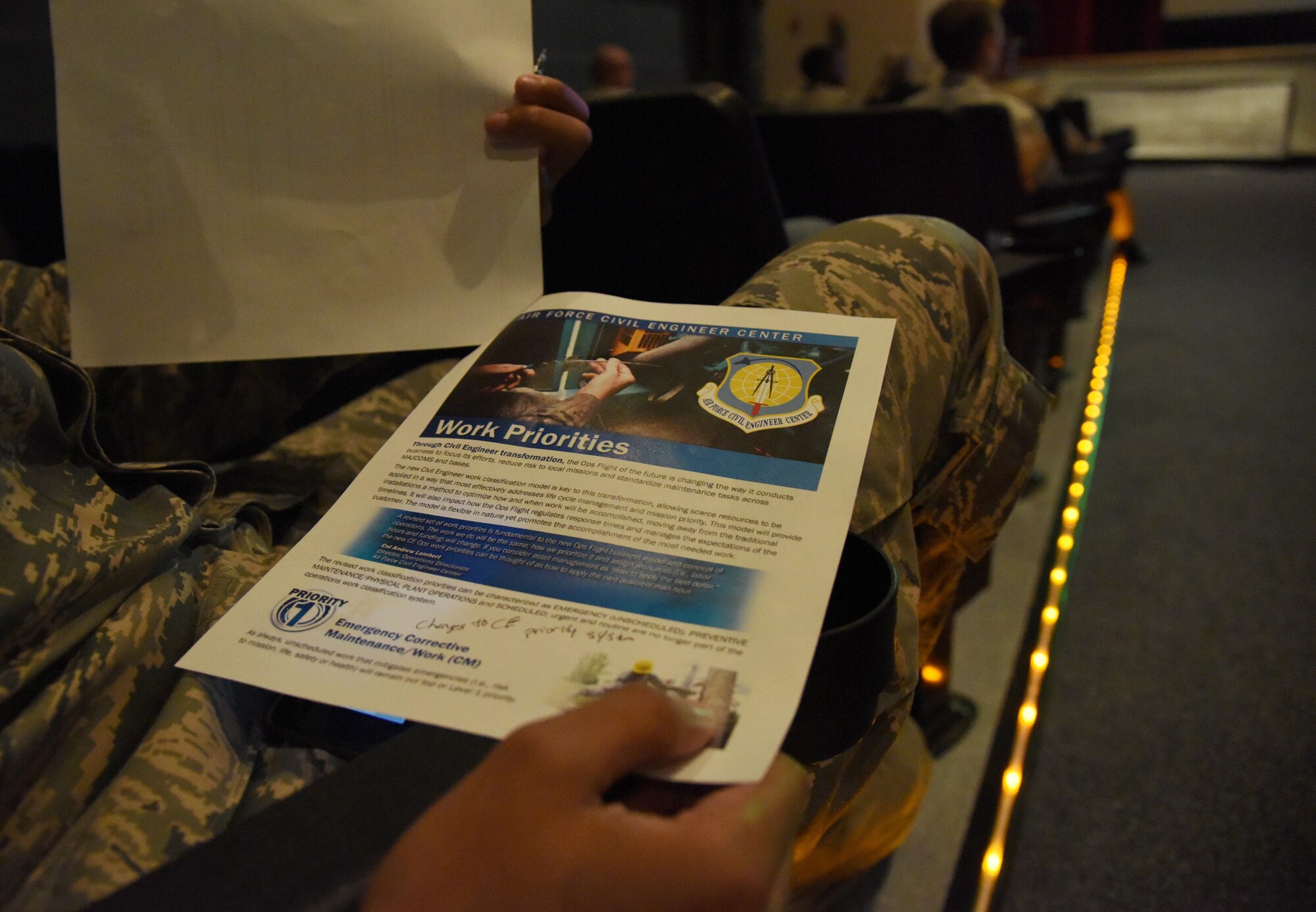 Staff Sgt. Cortez Willis, 602nd Training Group (Provisional) personnel support of contingency operations technician, reviews a work priority printout during the Base Operations Support town hall meeting at the Welch Theater July 26, 2017, on Keesler Air Force Base, Miss. The meeting was to discuss the new base operations support contract revisions. (U.S. Air force photo by Kemberly Groue)