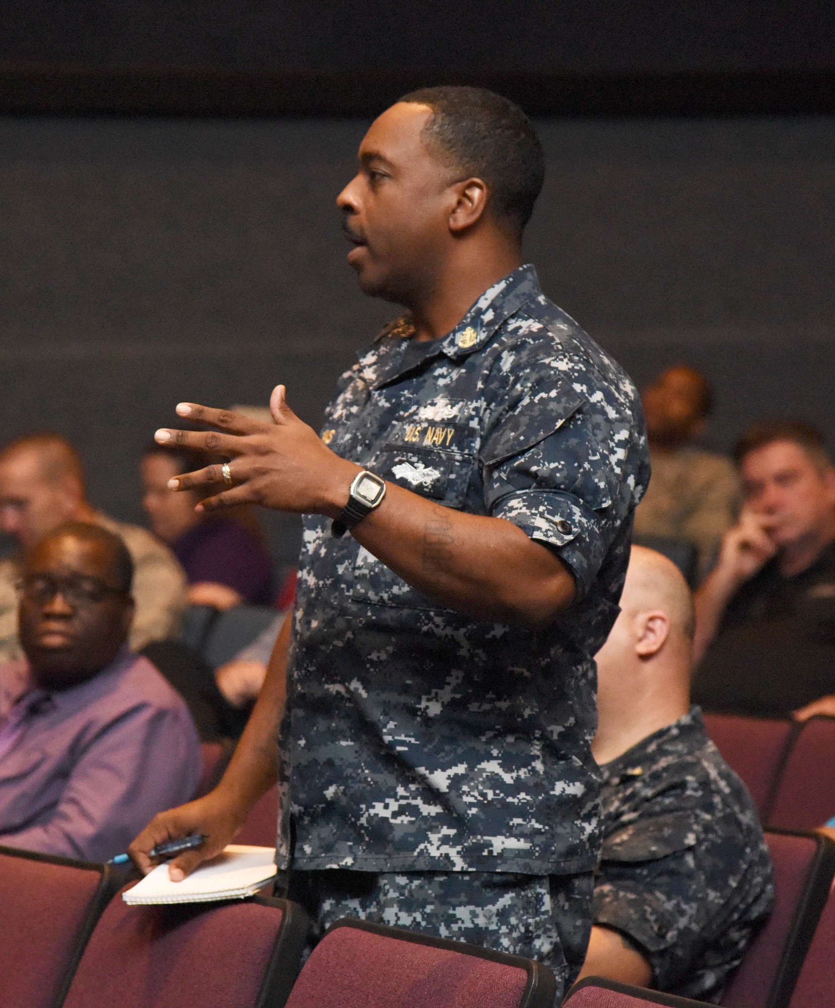 U.S. Navy Chief Petty Officer Andre Syas, Center for Naval Aviation Technical Training Unit Keesler facility manager, asks questions during the Base Operations Support town hall meeting at the Welch Theater July 26, 2017, on Keesler Air Force Base, Miss. The meeting was to discuss the new base operations support contract revisions. (U.S. Air force photo by Kemberly Groue)