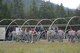 Airmen from the 819th RED HORSE Squadron set up tent frames for two Alaskan small system shelters during an exercise July 27, 2017, at the Benchmark Airport near Augusta, Mont.