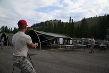 Airmen from the 819th RED HORSE Squadron pull tent fabric to cover an Alaskan small system shelter during an exercise July 27, 2017, at the Benchmark Airport near Augusta, Mont.
