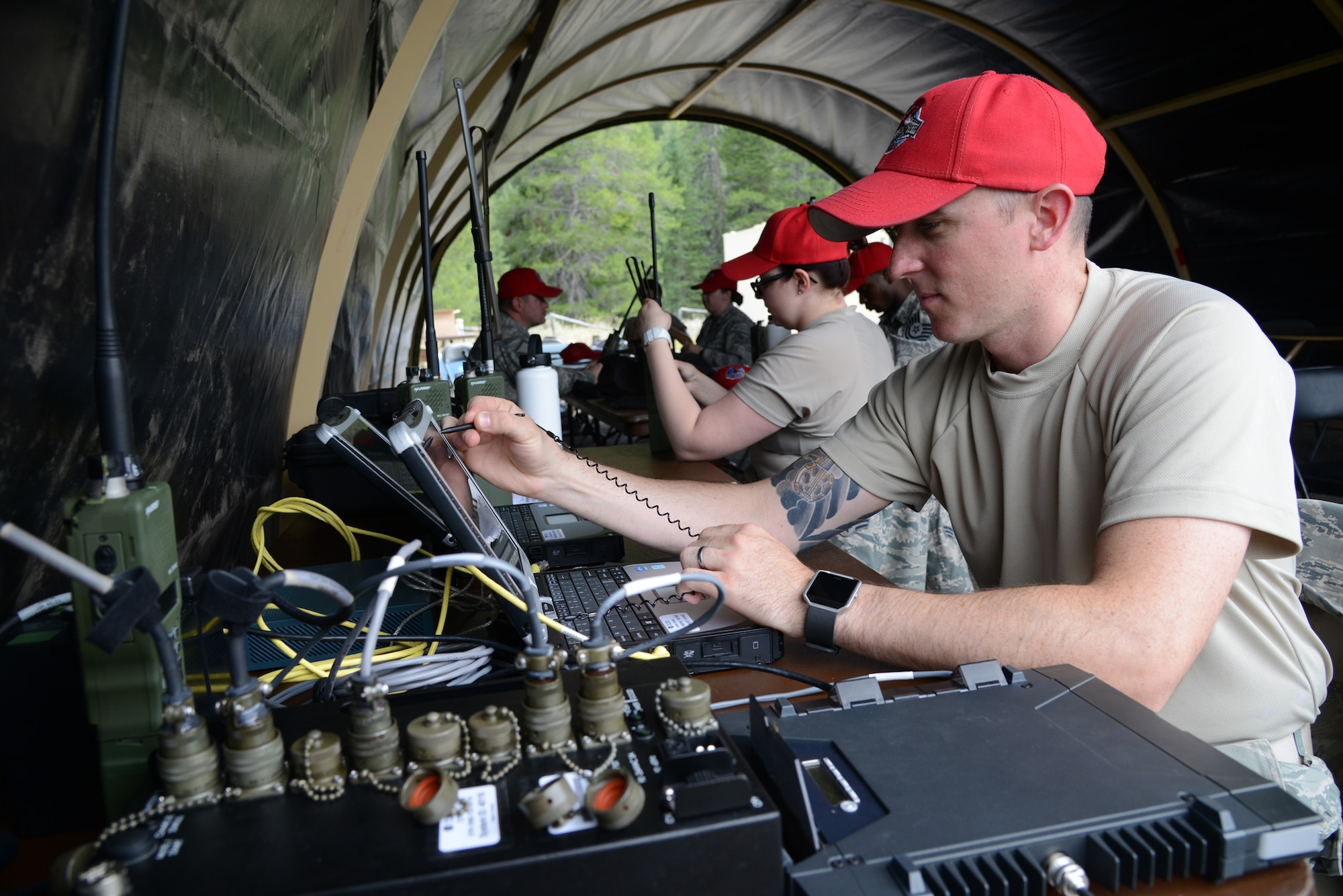 Staff Sgt. Wesley Bear, 819th RED HORSE Squadron NCO in charge of client systems, sets up communications equipment during an exercise July 27, 2017, at the Benchmark Airport near Augusta, Mont.