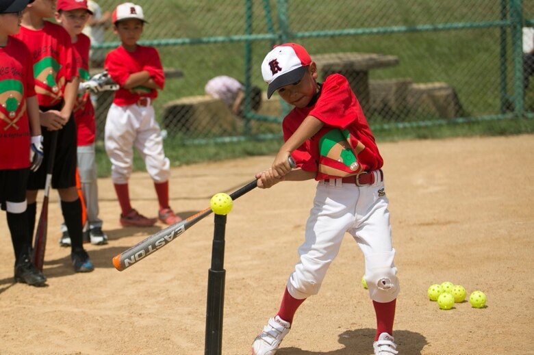 A child practices batting at a youth baseball clinic
