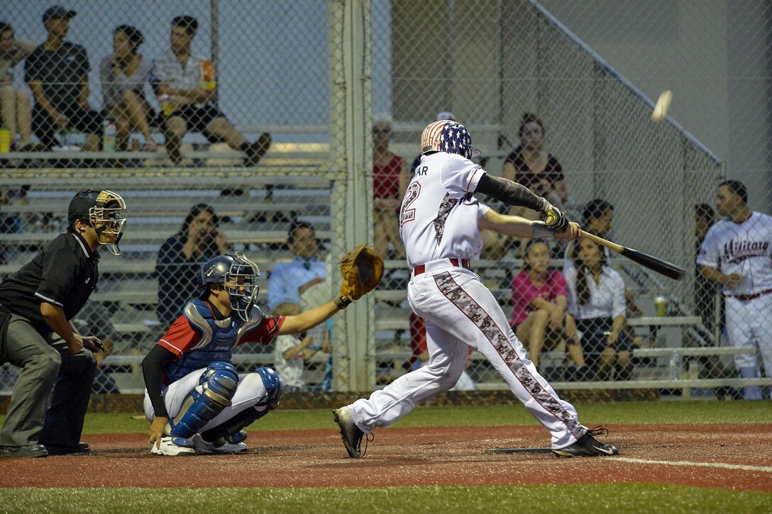 Navy Petty Officer 3rd Class Michael S. Parmer hits a pitch during a baseball game between USA Military Baseball Team Pacific and the Baseball First League All-Stars in Yokosuka, Japan, July 28, 2017. Parmer is a machinist's mate assigned to the USS Blue Ridge, the U.S. 7th Fleet flagship, which is in maintenance to modernize it. Navy photo by Petty Officer 3rd Class Patrick Semales