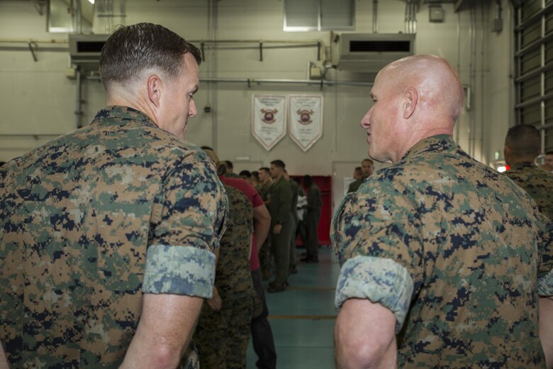 U.S. Marine Corps Col. Richard F. Fuerst, right, the commanding officer of Marine Corps Air Station (MCAS) Iwakuni, congratulates Chief Warrant Officer 2 Adam James, the officer in charge of aircraft recovery with Headquarters and Headquarters Squadron (H&HS), on winning the 2016 ARFF Unit of the Year and the 2016 United States Marine Corps Small Fire Department of the Year at MCAS Iwakuni, Japan, Aug. 1, 2017. They were the first ARFF unit to win the United States Marine Corps Small Fire Department of the Year and develop discrete emergency frequencies for emergency aircraft. They created the official ARFF qualification checklist and were the first to implement an assistant chief of operations and station captain. They also created the first ARFF emergency response binders to standardize all responses throughout ARFF units in the Marine Corps. (U.S. Marine Corps photo by Lance Cpl. Gabriela Garcia-Herrera)