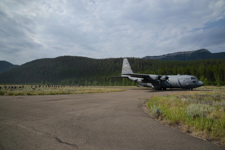 Airmen from the 819th RED HORSE Squadron depart a C-130 Hercules aircraft from the 120th Airlift Wing, Montana Air National Guard, July 27, 2017, at the Benchmark Airport near Augusta, Mont.