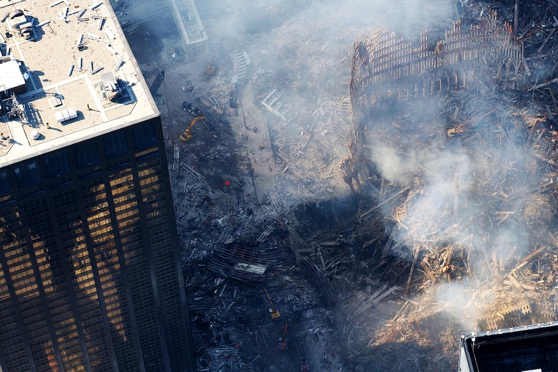 An aerial view shows smoke wafting from ground zero.