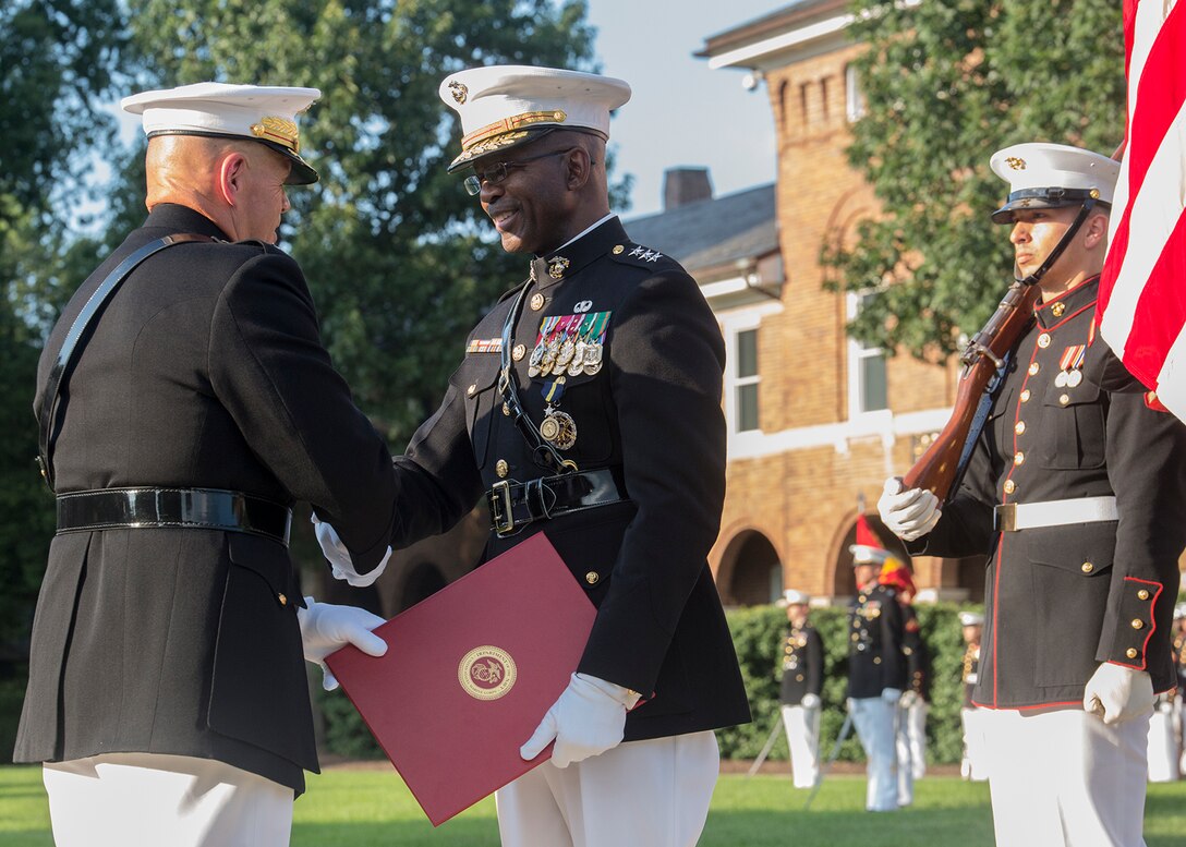 The Commandant of the Marine Corps, Gen. Robert B. Neller, passes an award warrant to Lt. Gen. Ronald L. Bailey, deputy commandant, Plans, Policies, and Operations, during a retirement ceremony for Bailey at Marine Barracks Washington D.C., July, 31, 2017. Bailey was most recently assigned to Headquarters Marine Corps and served 40 honorable years in the Corps. (Official Marine Corps photo by Cpl. Robert Knapp/Released)