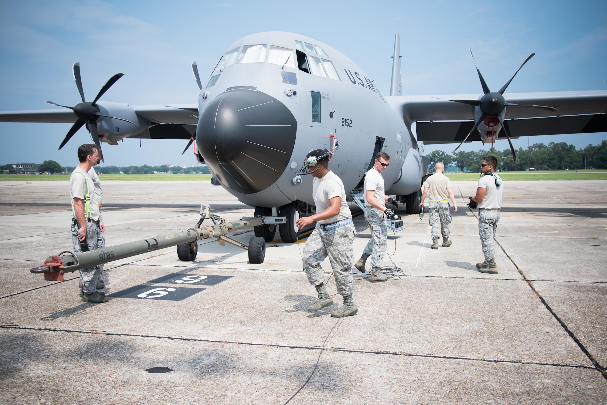 Members of the 913th Maintenance Squadron from Little Rock Air Force Base, Arkansas work together with members of the 803rd Aircraft Maintenance Squadron to hook up a C-130J Super Hercules aircraft to be towed to the wash rack July 21, 2017 at Keesler AFB, Mississippi. (U.S. Air Force photo/Staff Sgt. Heather Heiney)