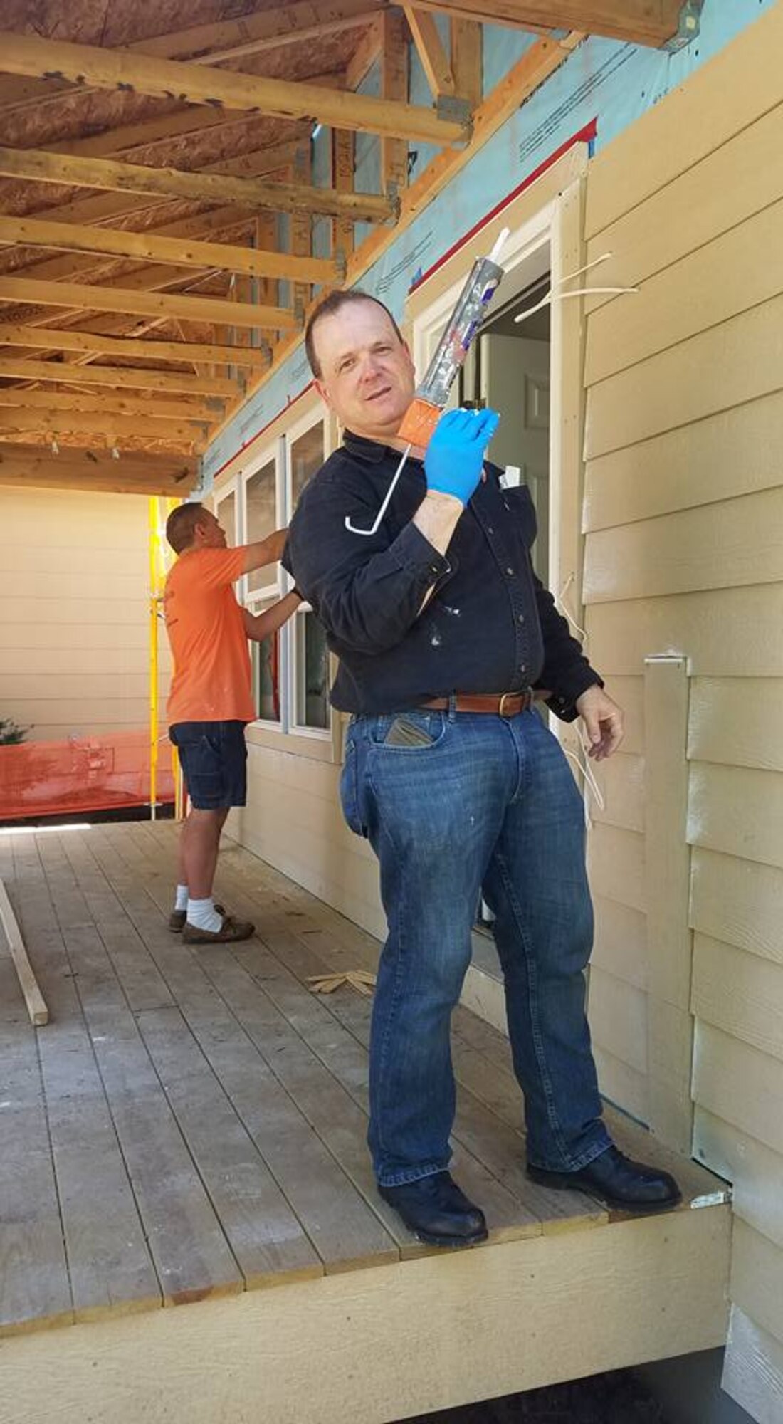 Col. Craig Petersen, 934th Mission Support Group commander, applies caulk during a Habitat for Humanity project in St. Paul Aug. 28. (Courtesy Photo)