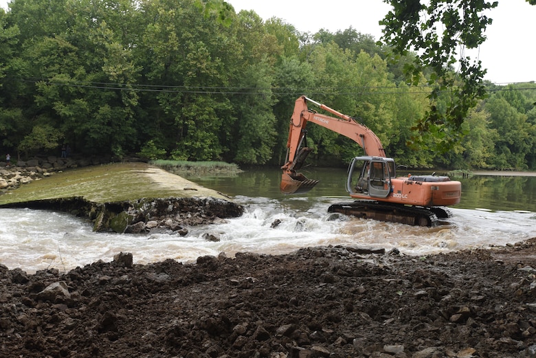 An excavator moves into position to remove Roaring River Dam in Jackson County, Tennessee Aug. 1, 2017.