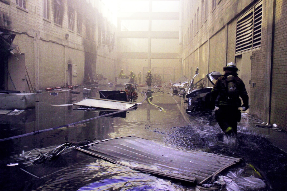 A firefighter approaches the crash site at the Pentagon.