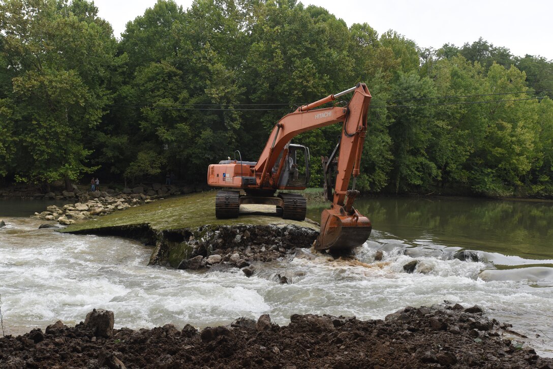 An excavator removes the concrete cap from Roaring River Dam in Jackson County, Tennessee Aug. 1, 2017.