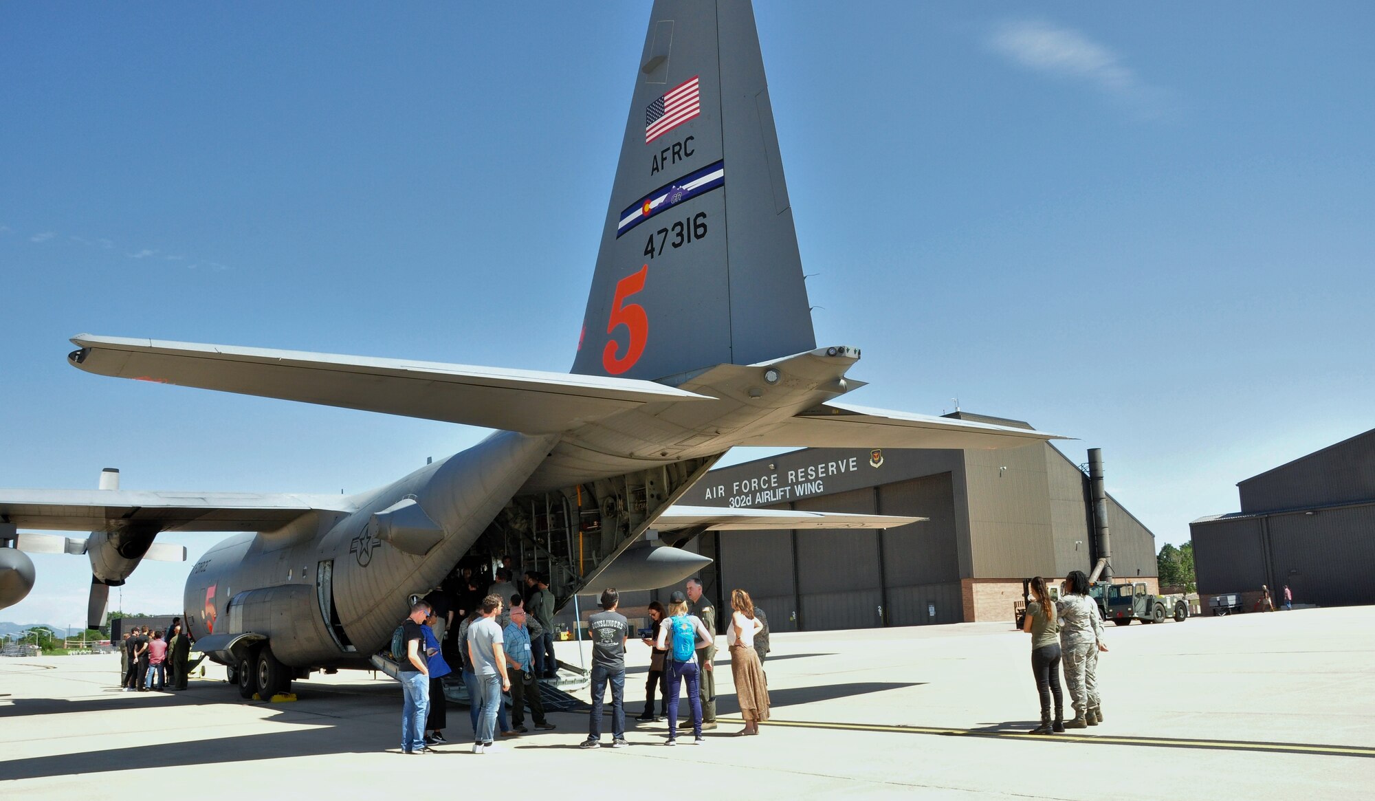 Representatives of various entertainment offices out of Los Angeles separated into various groups learn about the 302nd Airlift Wing and its Reserve missions involving C-130 Hercules aircraft at Peterson Air Force Base, Colo., July 18, 2017.