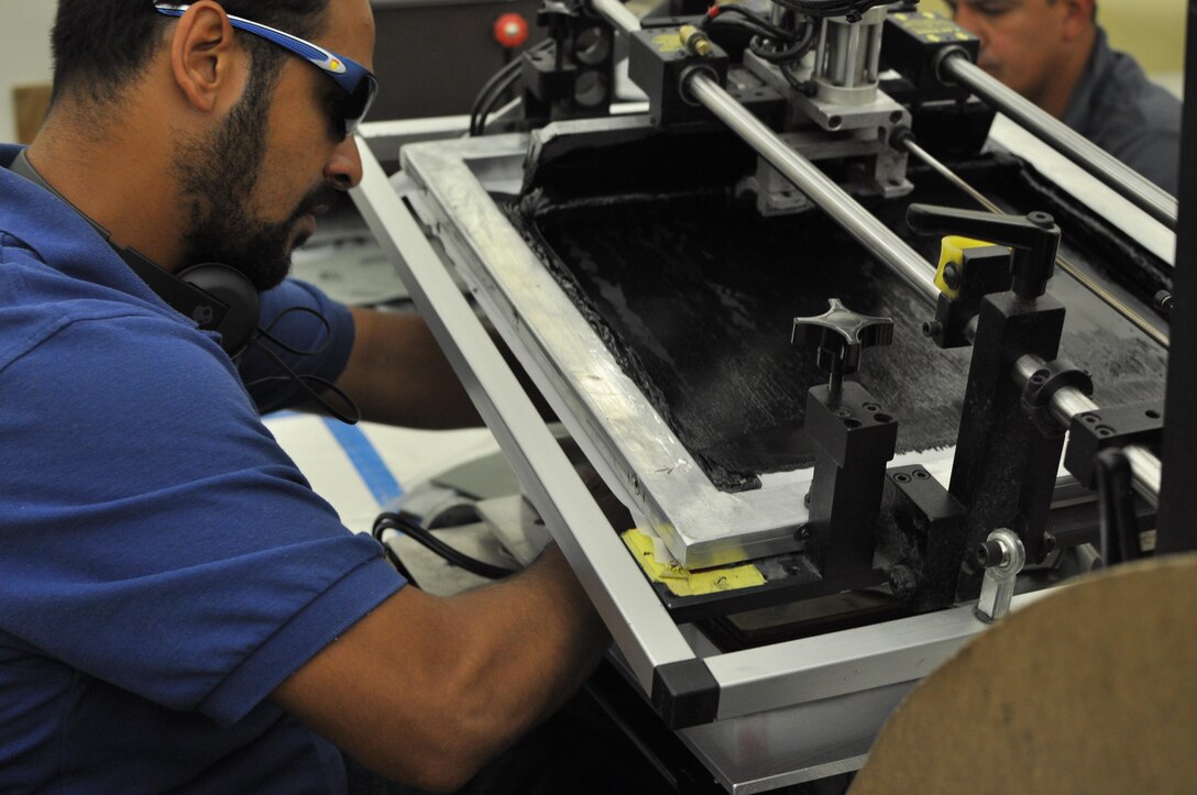 A Vision Corps employee assembles cushion pads for an Army combat helmet at the company’s manufacturing facility in Lancaster, Pennsylvania July 26. DLA Troop Support Clothing and Textiles employees toured production lines, where blind or visually impaired individuals operated machinery or packaged item parts.