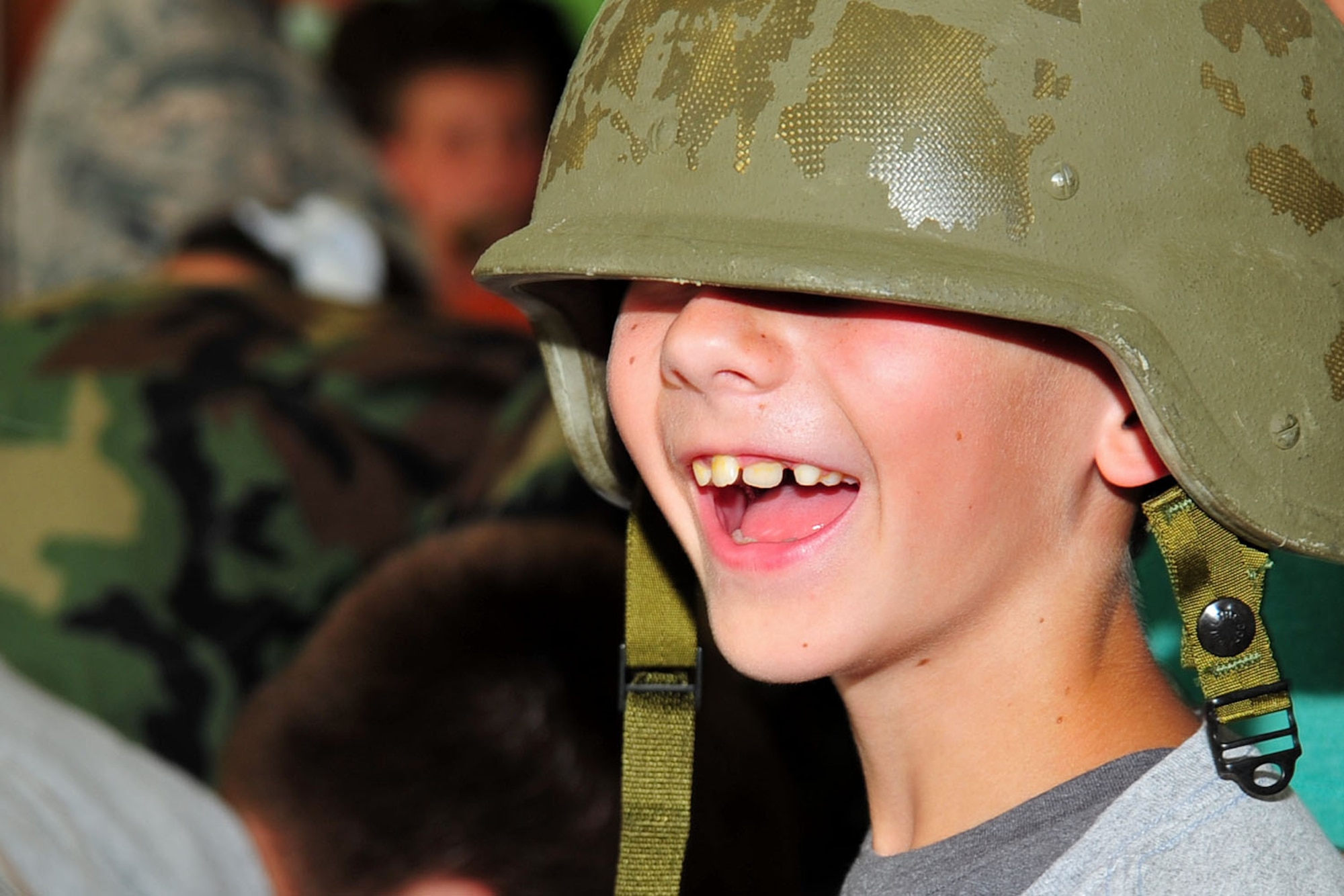 A Team Shaw child wears a helmet during a Kids Meet the Shaw Weasels event, hosted by 20th Force Support Squadron Airman and Family Readiness Center, at Shaw Air Force, S.C., July 28, 2017. During the event, children had the opportunity to try on individual protective equipment and get a close look at a 20th Fighter Wing F-16CM Fighting Falcon. (U.S. Air Force photo by Airman 1st Class Kathryn R.C. Reaves)