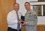 Chief Master Sgt. Roger Towberman, former command chief for 25th Air Force, receives recognition from Steven Doucette, chief of staff, 25th Air Force, during his departure luncheon July 27, 2017.
