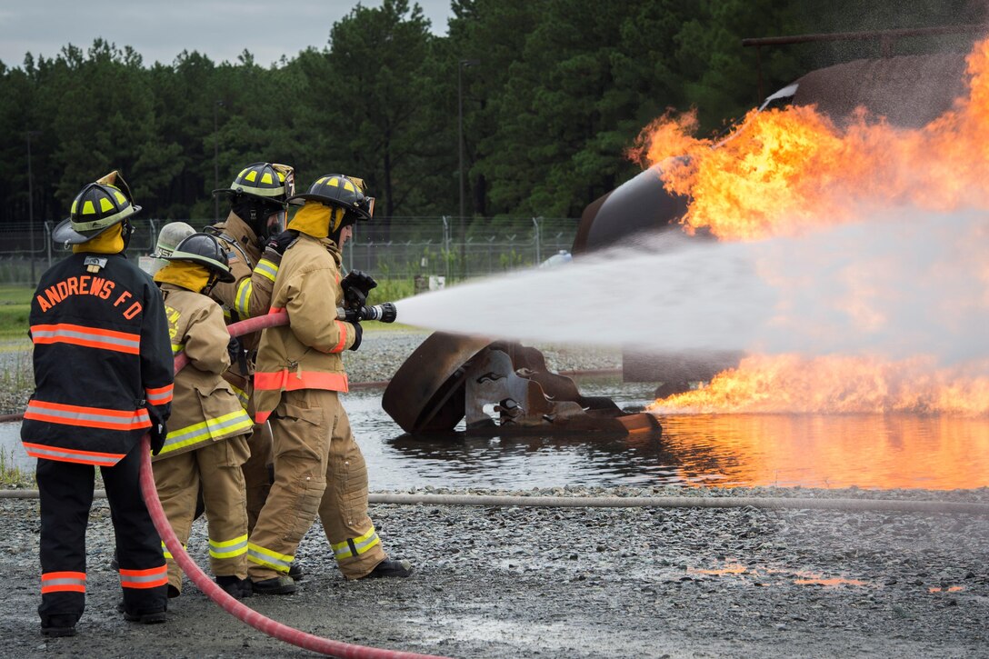 Joint Base Andrews Fire Explorer Academy cadets test hose lines during a training exercise.