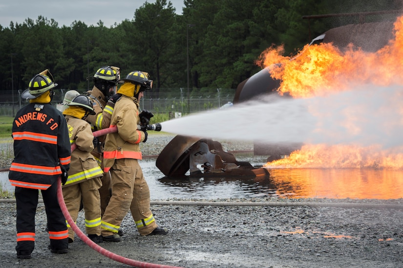 Joint Base Andrews Fire Explorer Academy cadets test hose lines during a training exercise.